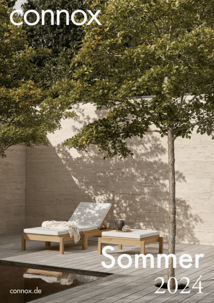 Connox catalog cover summer 2024. A relaxed white/beige garden with beautiful wooden furniture.