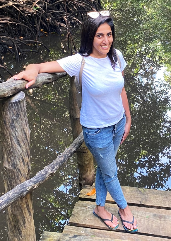 Photo of Arrainaa in grey shirt, long hair, and sunglasses.