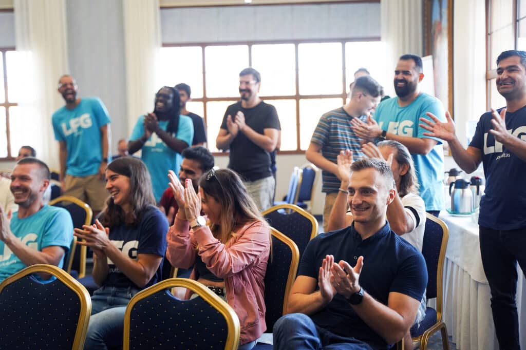 Publitas employees clapping in a meeting room.