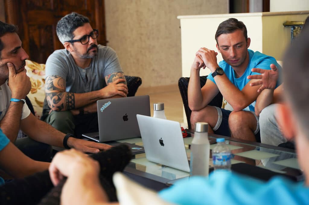 Publitas employees sitting around a table, discussing work.