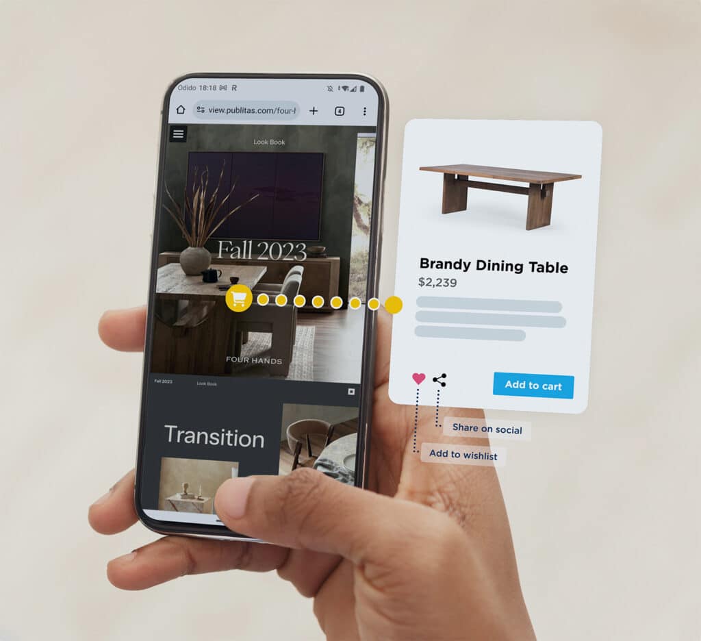 Close up of a mobile phone held in hand. The display shows a home decor catalog and a product page for a Brandy Dining Table (with add to cart button).