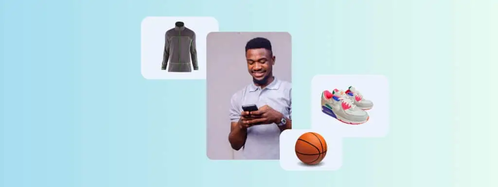 A man on his phone surrounded by a basketball, sneakers and a running top