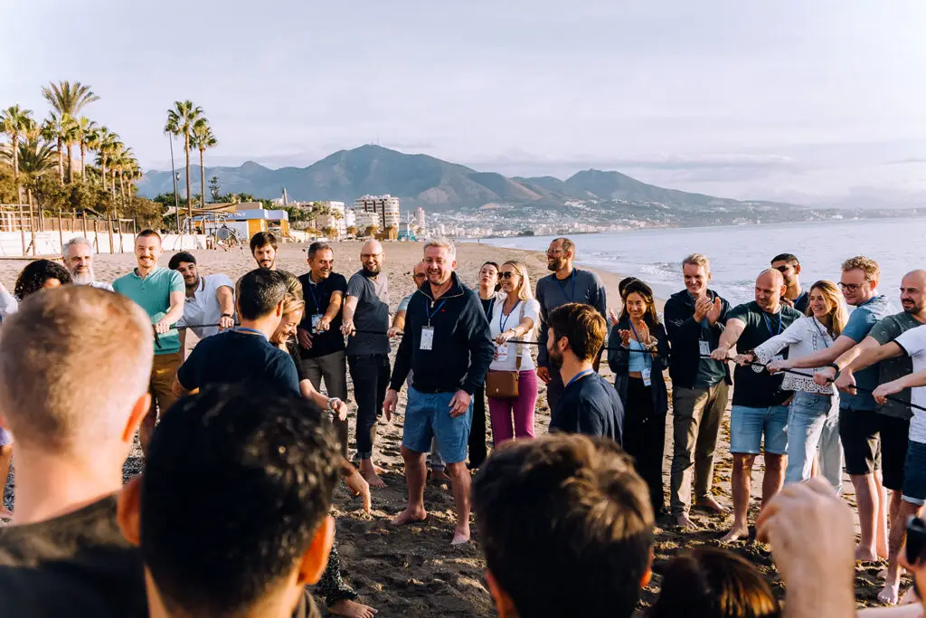 Group of Publitas employees doing a team activity on the beach.