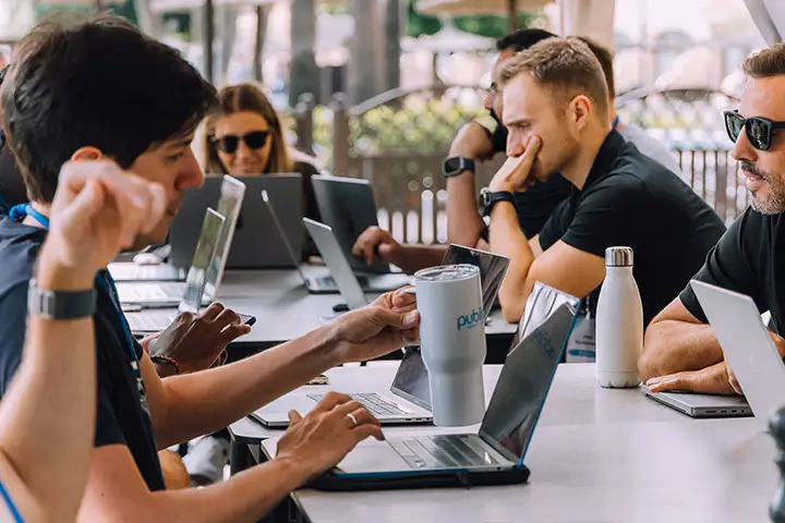 Publitas team at work on laptops.
