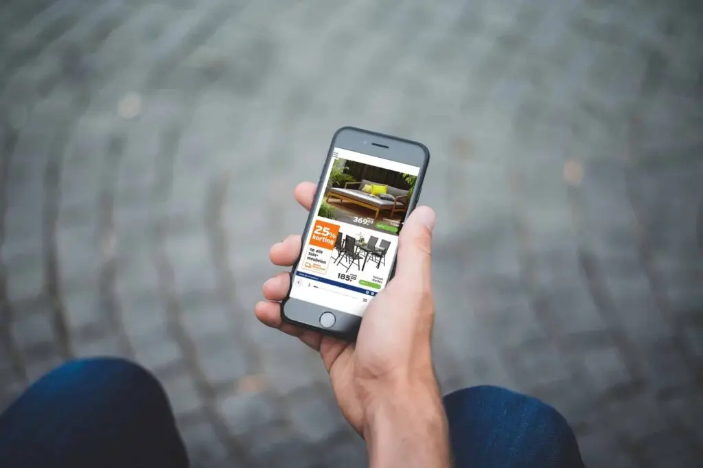 How Gamma Tested and Improved the ROI of Their Digital Brochure 16 A man holding a phone displaying GAMMA's mobile-optimized leaflet. A clear grid, large text, and clear CTAs.