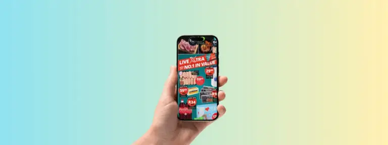 Image shows a hand holding a mobile phone that has a supermarket digital catalog on the screen